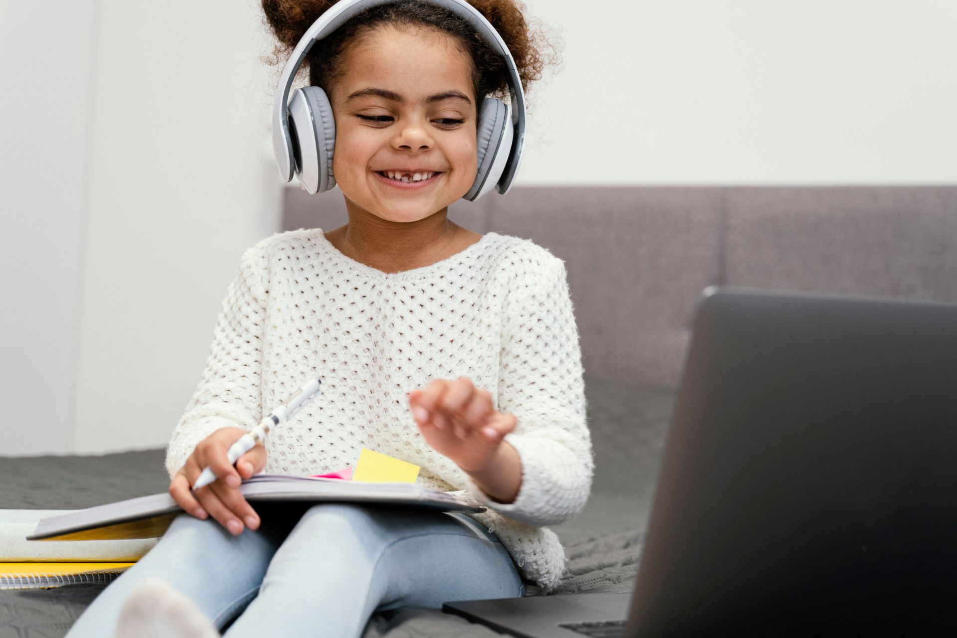 little girl doing Online Schooling