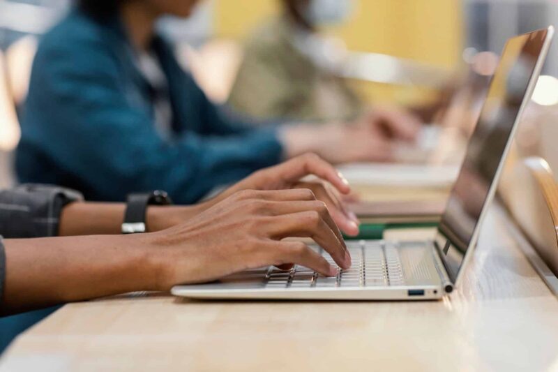 hands typing on a laptop